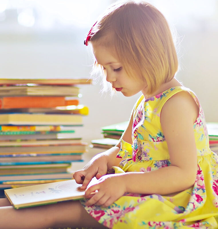 Young child learning to read at Nurturing Knowledge Preschool in Seattle